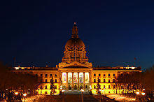 Provincial Legislature of Alberta lit up by exterior lighting during a winter night.